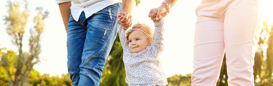 Parents walking with baby while holding hands